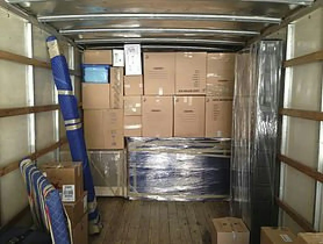 Moving boxes and protective blankets loaded inside a moving truck